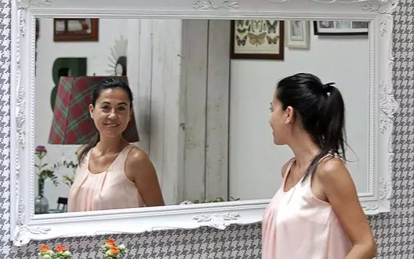 15 Woman looking at herself in the mirror
